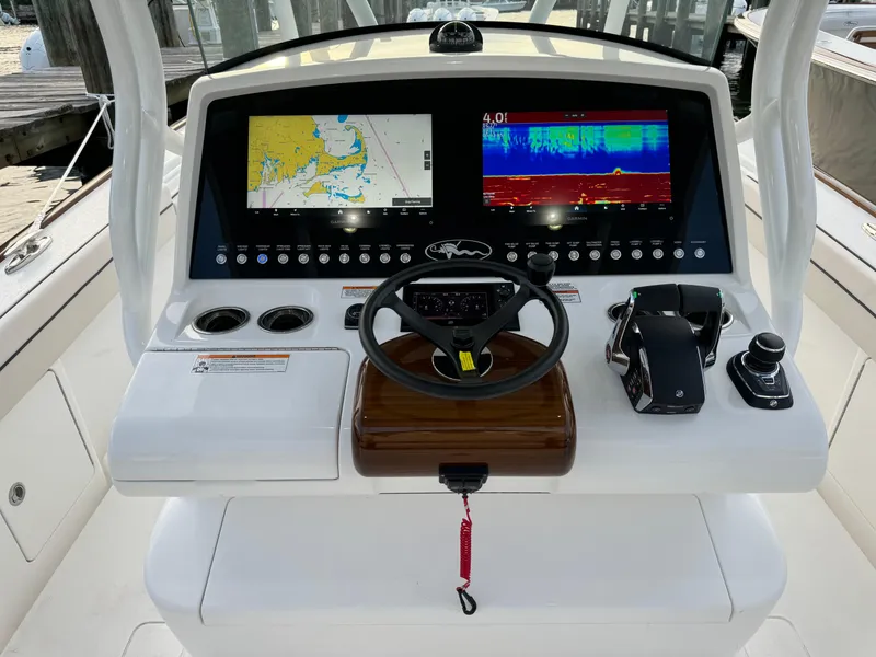 Slide: The Image of 2025 Valhalla Boatworks V-33 helm with dual navigation screens and controls. - 34