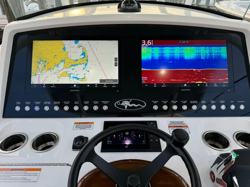 Slide: The Image of 2025 Valhalla V-33 boat dashboard with dual navigation screens and controls. - 35