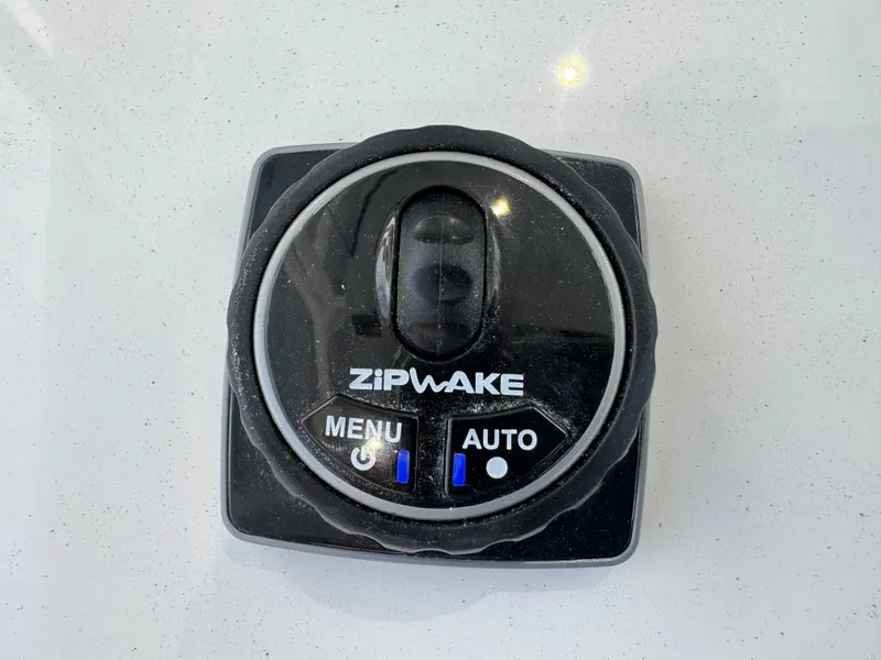 Slide: The Image of Zipwake control panel on 2025 Valhalla Boatworks V-33, featuring menu and auto options. - 38