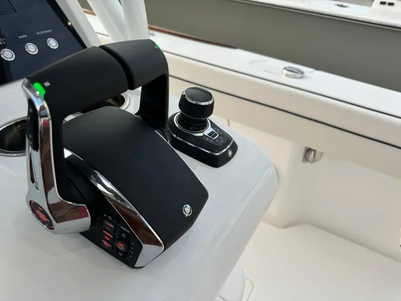 Slide: The Image of Close-up of 2025 Valhalla Boatworks V-33 control panel with throttle and joystick. - 39