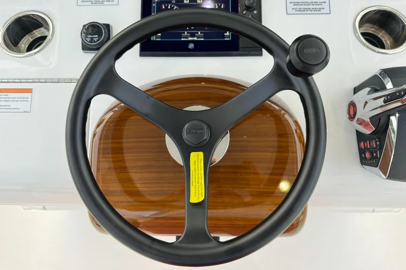 Slide: The Image of Steering wheel of 2025 Valhalla Boatworks V-33, featuring modern controls and wood accents. - 40