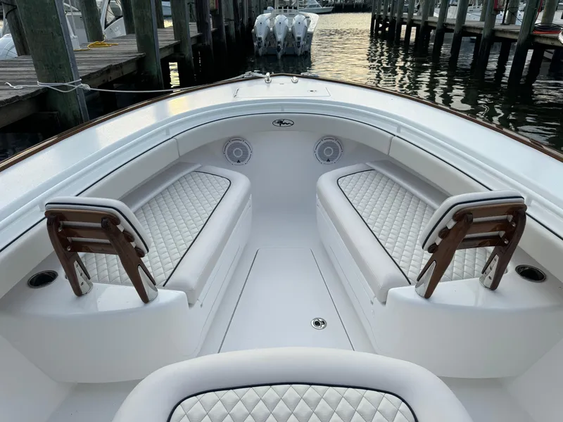 Slide: The Image of 2025 Valhalla Boatworks V-33 interior with white quilted seating at dock. - 44