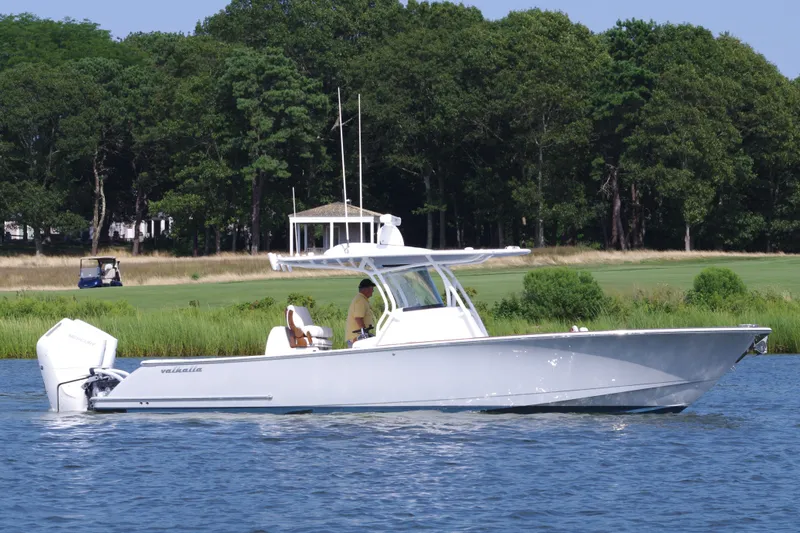 Slide: The Image of 2025 Valhalla Boatworks V-33 cruising on a serene lake with lush greenery. - 5