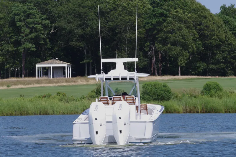 Slide: The Image of 2025 Valhalla Boatworks V-33 cruising on a serene lake with lush greenery. - 7