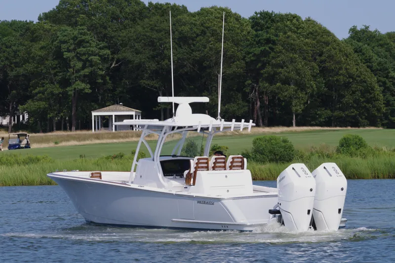 Slide: The Image of 2025 Valhalla Boatworks V-33 cruising on a serene lake with lush greenery. - 9