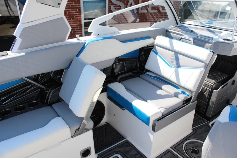 Slide: The Image of 2024 Tigé Ultré 25ZX boat interior with modern white and blue seating. - 12