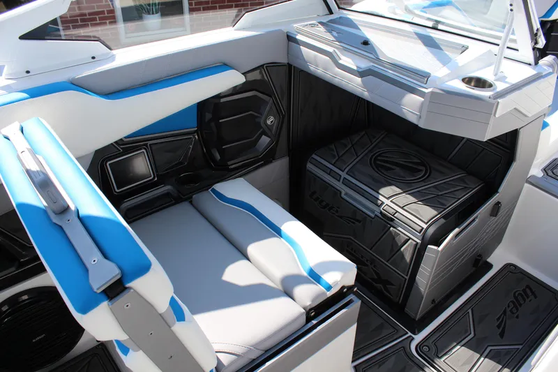 Slide: The Image of 2024 Tigé Ultré 25ZX boat interior with blue and white seating and storage. - 13