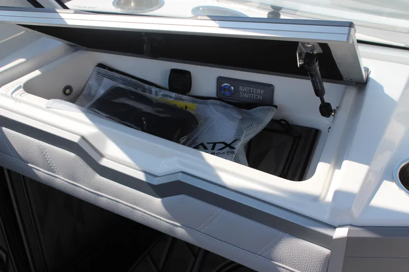 Slide: The Image of 2024 Tigé Ultré 25ZX boat storage compartment with battery switch and accessories. - 15