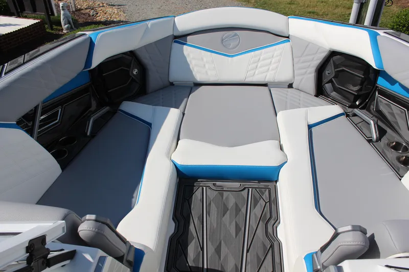 Slide: The Image of 2024 Tigé Ultré 25ZX boat interior with gray and blue seating. - 17