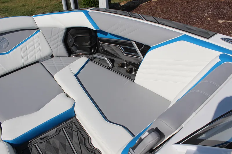 Slide: The Image of 2024 Tigé Ultré 25ZX boat interior with white and blue seating. - 18
