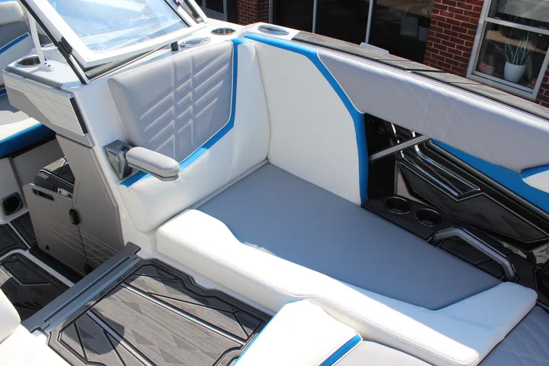 Slide: The Image of 2024 Tigé Ultré 25ZX boat interior with sleek white and blue seating. - 19