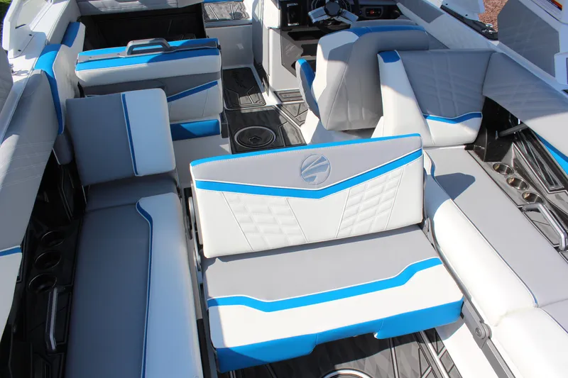 Slide: The Image of 2024 Tigé Ultré 25ZX boat interior with blue and white seating. - 21