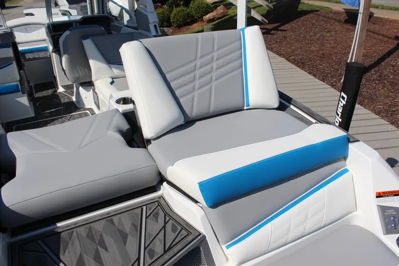 Slide: The Image of 2024 Tigé Ultré 25ZX boat interior with modern seating and blue accents. - 7