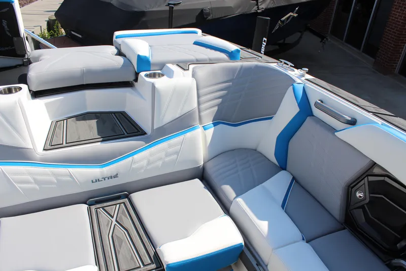 Slide: The Image of 2024 Tigé Ultré 25ZX boat interior with modern seating and blue accents. - 8