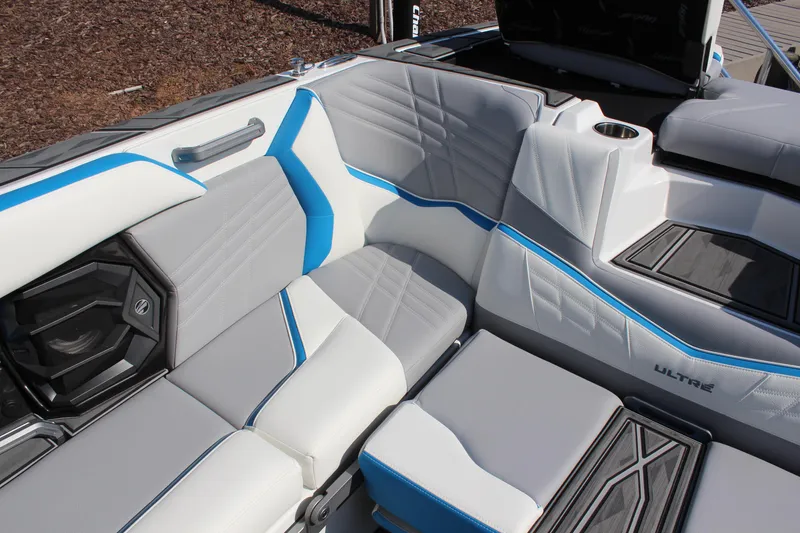 Slide: The Image of 2024 Tigé Ultré 25ZX boat interior with gray and blue seating. - 9