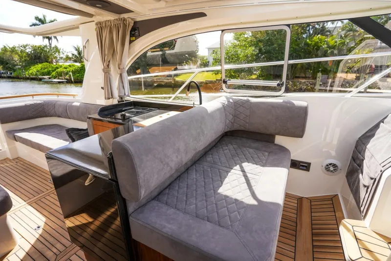 Slide: The Image of 2025 Marex 360 Cabriolet Cruiser interior with plush seating and elegant wood flooring. - 17