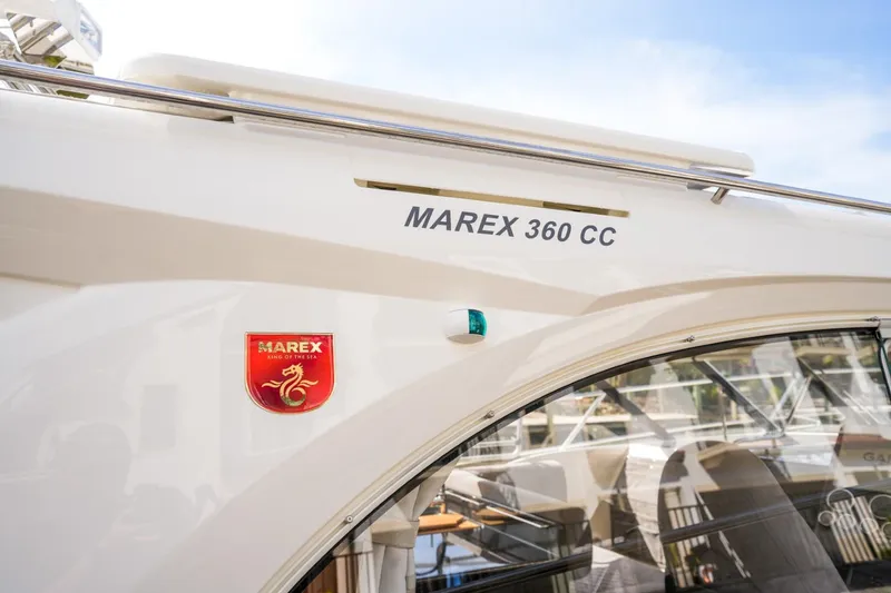 Slide: The Image of 2025 Marex 360 Cabriolet Cruiser exterior with logo and model name. - 25