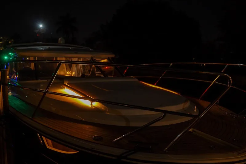 Slide: The Image of 2025 Marex 360 Cabriolet Cruiser illuminated at night, showcasing sleek design and elegant lighting. - 26