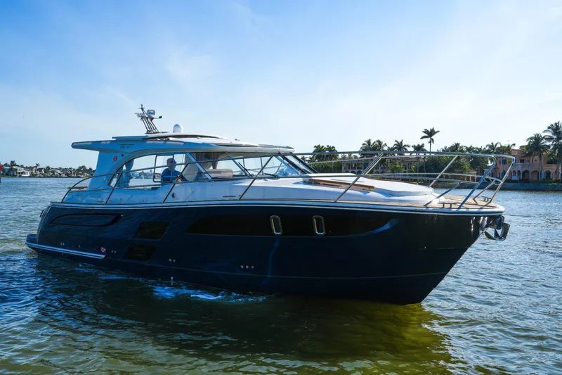 Slide: The Image of 2025 Marex 360 Cabriolet Cruiser on water, sleek design, sunny day, palm trees in background. - 8