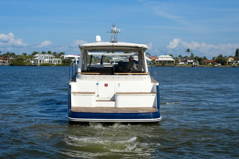 Slide: The Image of 2025 Marex 360 Cabriolet Cruiser on calm waters, rear view. - 12