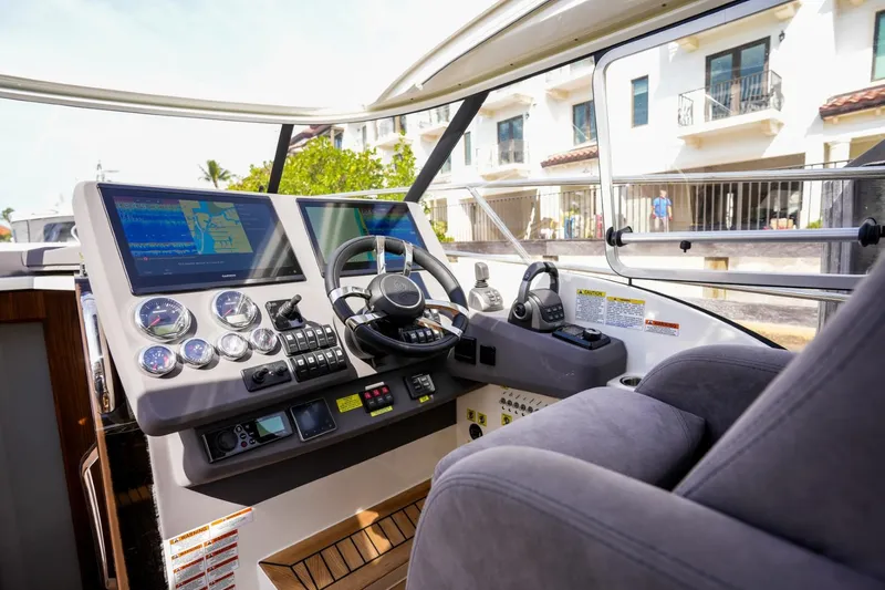 Slide: The Image of Cockpit of 2025 Marex 360 Cabriolet Cruiser with modern navigation instruments and plush seating. - 19