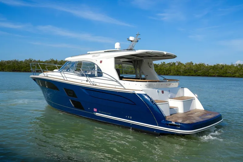 Slide: The Image of 2025 Marex 360 Cabriolet Cruiser on calm water, showcasing sleek design and luxury features. - 1