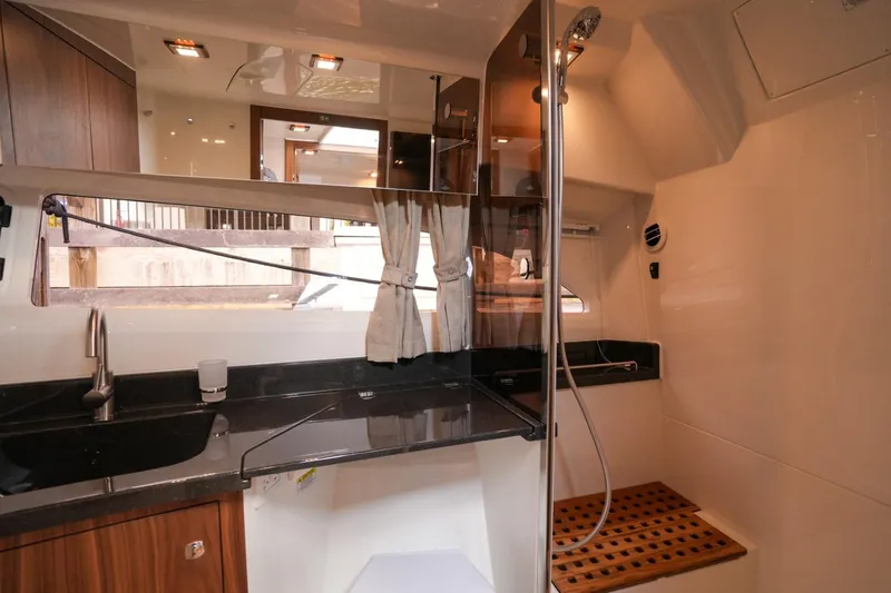 Slide: The Image of Interior of 2025 Marex 360 Cabriolet Cruiser, featuring modern kitchen and shower area. - 21