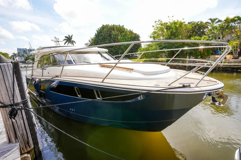 Slide: The Image of 2025 Marex 360 Cabriolet Cruiser docked in a serene marina setting. - 29