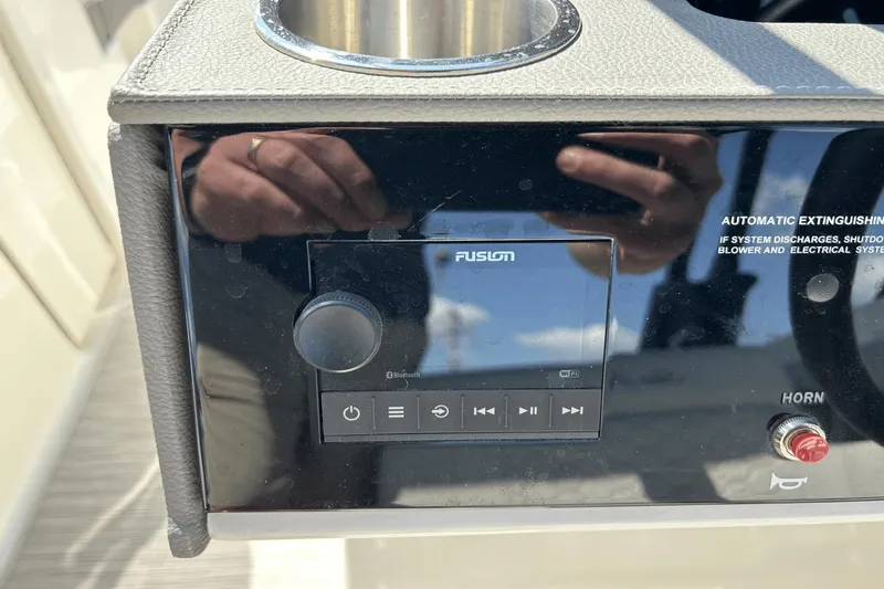 Slide: The Image of Control panel of 2022 Sea Ray 270 Sundeck Outboard with Fusion audio system. - 15