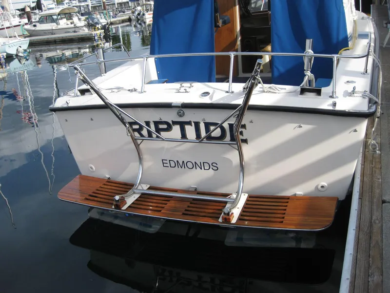 Slide: The Image of 1977 Chris-Craft 28' Cruiser docked, featuring "Riptide" and "Edmonds" on the stern. - 2
