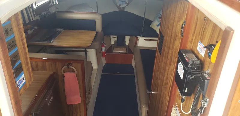 Slide: The Image of 1977 Chris-Craft 28' Cruiser interior with wood paneling and seating area. - 20