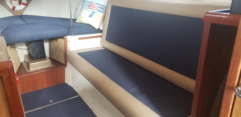 Slide: The Image of 1977 Chris-Craft 28' Cruiser interior with blue and beige seating, nautical decor. - 23