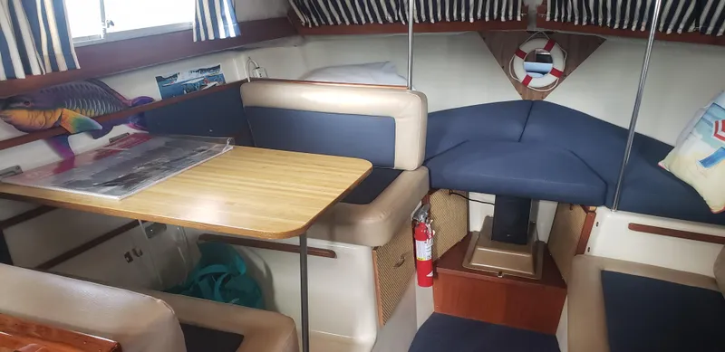 Slide: The Image of 1977 Chris-Craft 28' Cruiser interior with seating, table, and nautical decor. - 24
