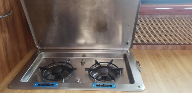 Slide: The Image of 1977 Chris-Craft 28' Cruiser kitchen with stainless steel two-burner stove. - 26