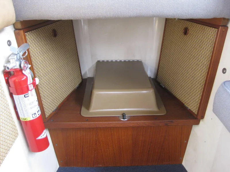 Slide: The Image of 1977 Chris-Craft 28' Cruiser interior with fire extinguisher and storage compartments. - 30