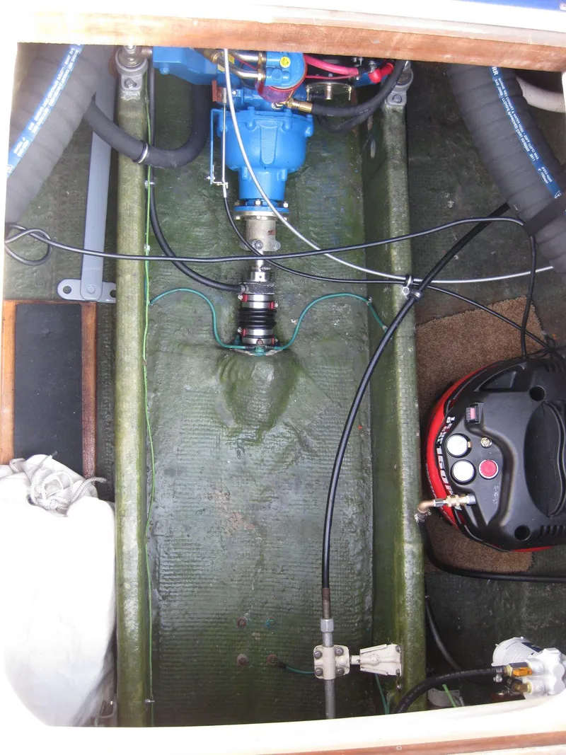 Slide: The Image of Engine compartment of a 1977 Chris-Craft 28' Cruiser with visible wiring and components. - 33