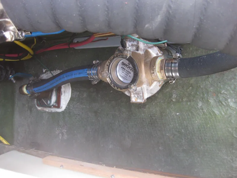 Slide: The Image of 1977 Chris-Craft 28' Cruiser engine compartment with hoses and pump system. - 35