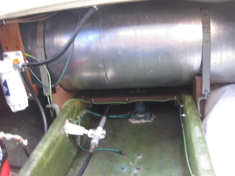 Slide: The Image of Engine compartment of a 1977 Chris-Craft 28' Cruiser, showing fuel tank and hoses. - 36