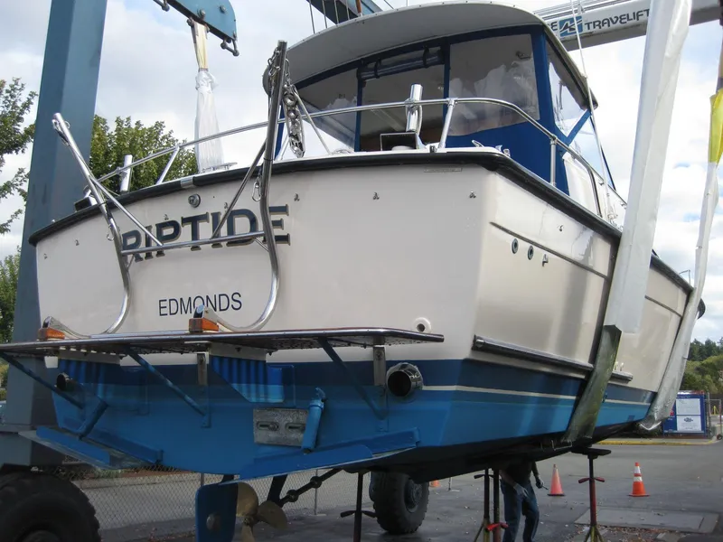 Slide: The Image of 1977 Chris-Craft 28' Cruiser on lift, rear view, blue and white hull. - 7