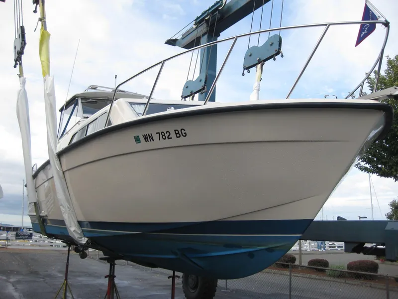 Slide: The Image of 1977 Chris-Craft 28' Cruiser boat on a lift, side view. - 8