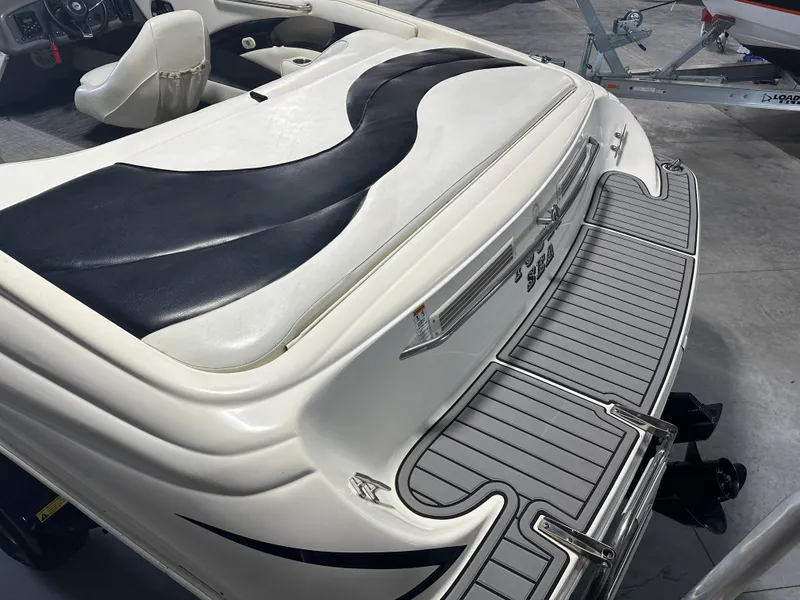 Slide: The Image of 1999 Rinker 212 Bowrider Captiva boat interior with sleek seating and swim platform. - 17