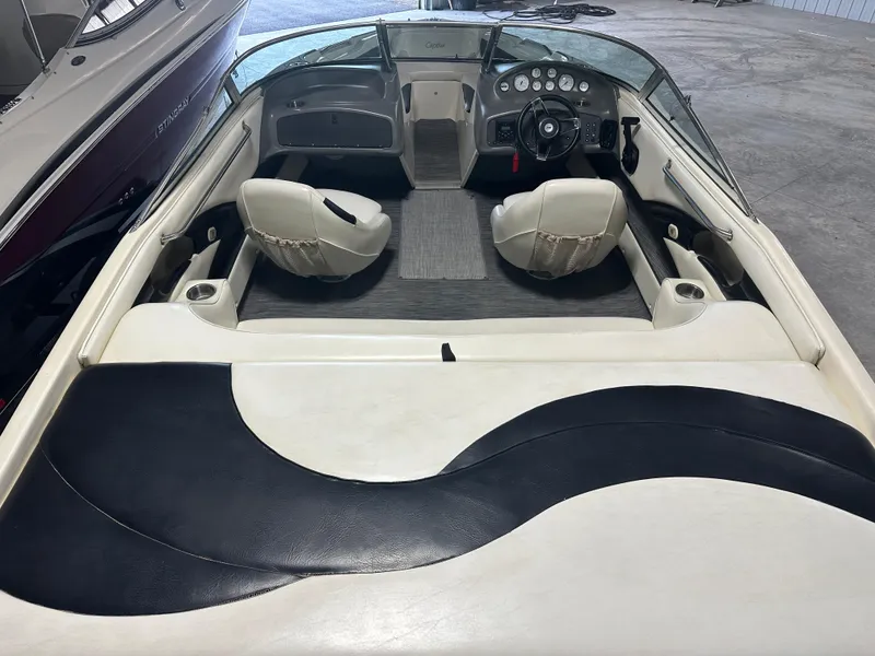 Slide: The Image of 1999 Rinker 212 Bowrider Captiva interior with steering wheel and seating. - 18