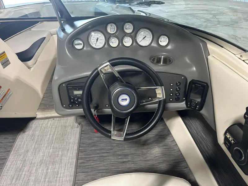 Slide: The Image of 1999 Rinker 212 Bowrider Captiva dashboard with steering wheel and gauges. - 21