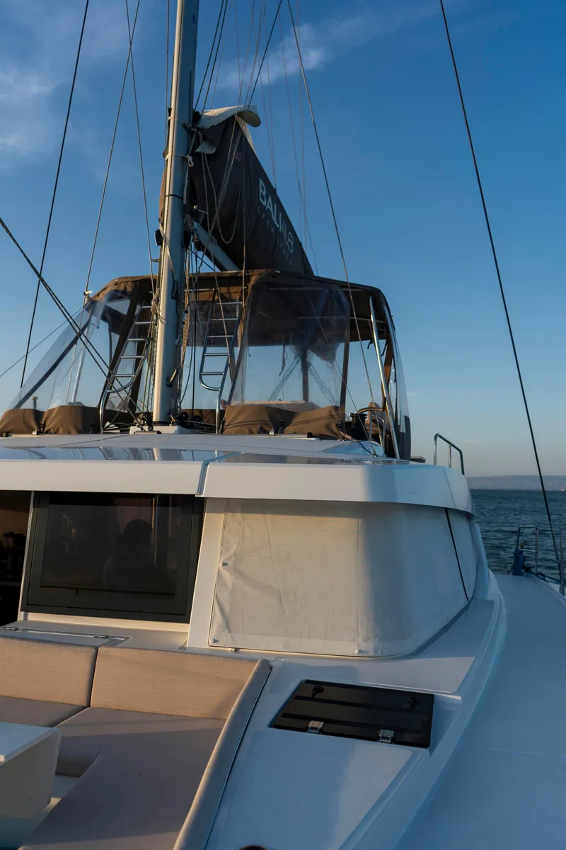 Slide: The Image of 2021 Bali 4.8 catamaran sailing on open water at sunset. - 14