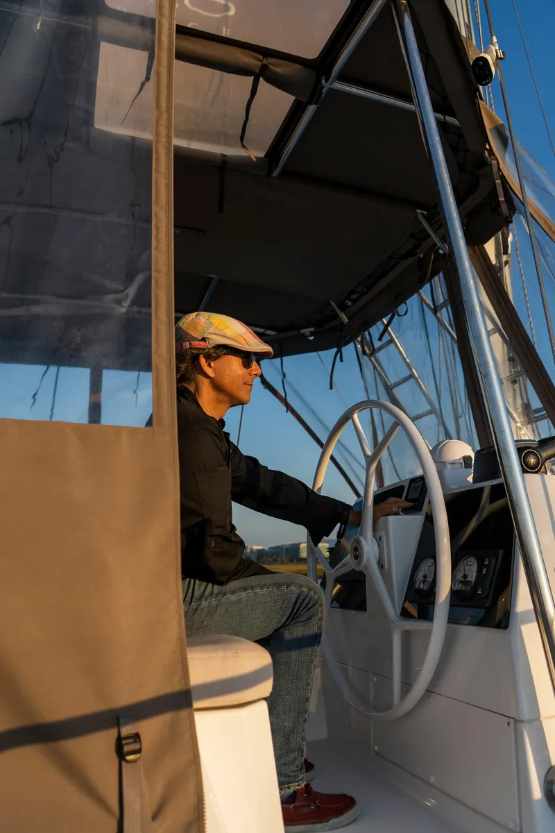 Slide: The Image of Person steering a 2021 Bali 4.8 yacht under a canopy, enjoying a sunny day. - 15
