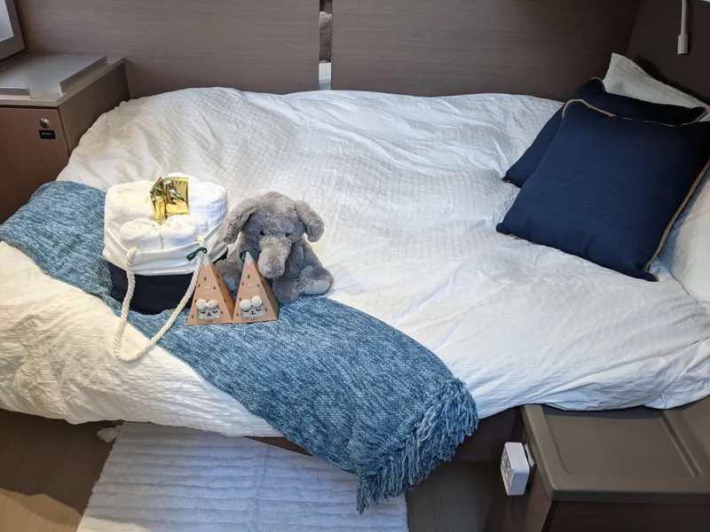 Slide: The Image of Cozy bed in 2021 Bali 4.8 yacht cabin with plush toys and blue accents. - 19