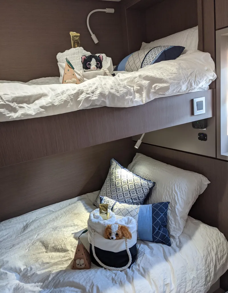 Slide: The Image of Cozy bunk beds in a 2021 Bali 4.8 yacht cabin with plush pillows and decor. - 25