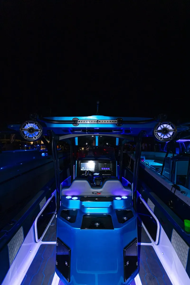 Slide: The Image of 2024 Glasstream GSX 36 boat interior with blue LED lighting at night. - 11