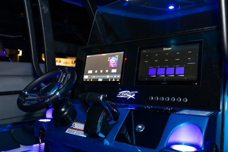 Slide: The Image of 2024 Glasstream GSX 36 boat dashboard with modern digital displays and steering wheel. - 13