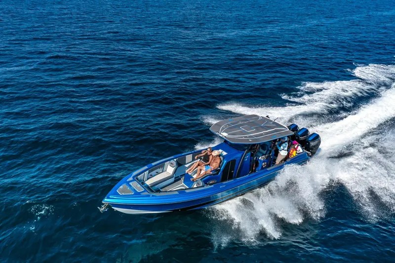 Slide: The Image of 2024 Glasstream GSX 36 speedboat cruising on open water, showcasing sleek design and powerful performance. - 2